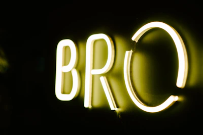 A bright, bold logo of Bad Boy Reviews glowing against a dark background.