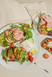 a white plate topped with a sandwich and salad