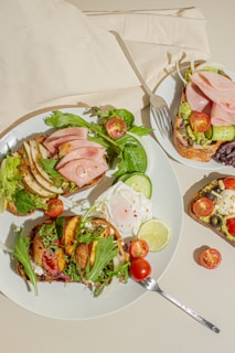 a white plate topped with a sandwich and salad