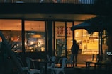 An inviting scene of a coffee shop with warm lighting.