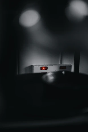 Close-up of a sleek, electric blue GPS tracker glowing softly on a dark tech background.