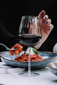 Hand crafted plated food & a glass of red wine at Tonic Martinborough