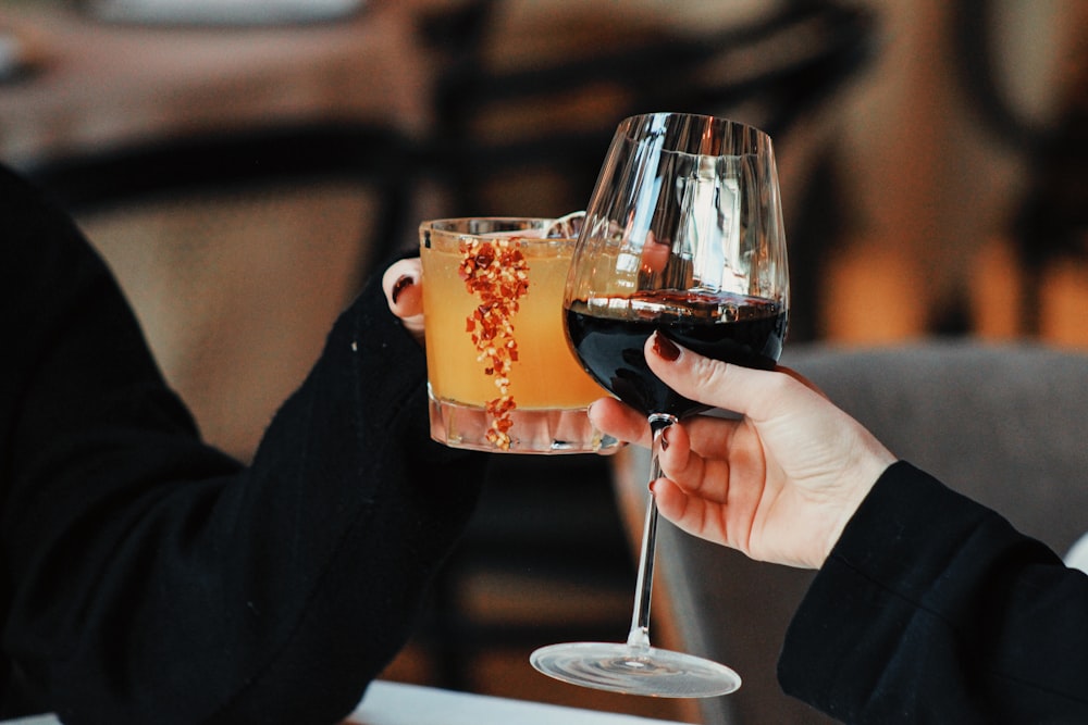 a couple of people holding glasses of wine