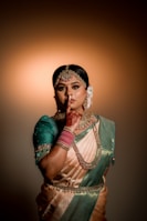 a woman in a sari poses for a picture