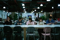 A diverse group of people using a health app on their smartphones in a bright, open space.