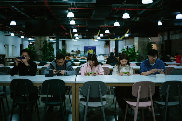 School cafeteria with students using digital devices for meal orders.