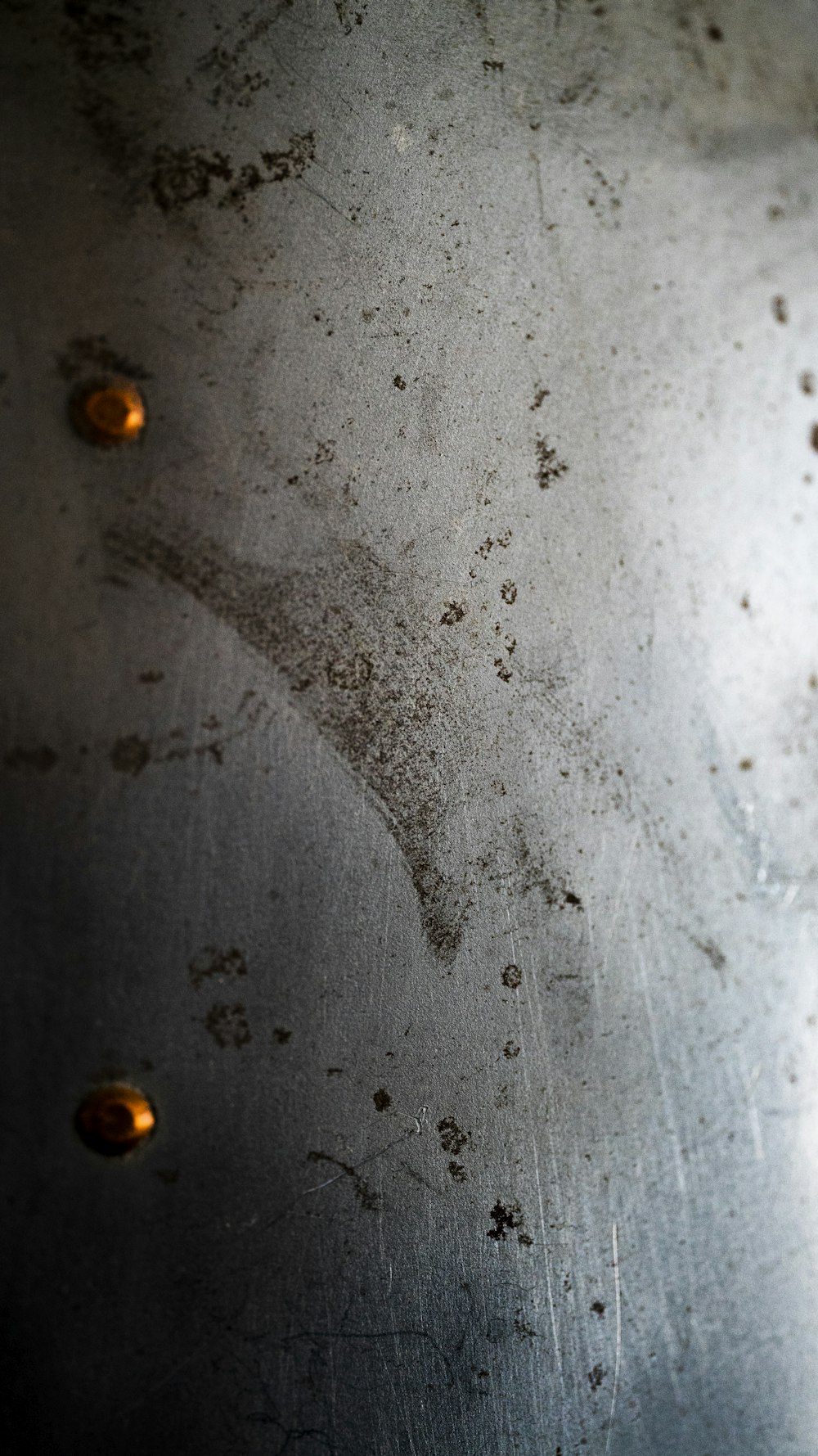 a close up of a metal plate with rivets