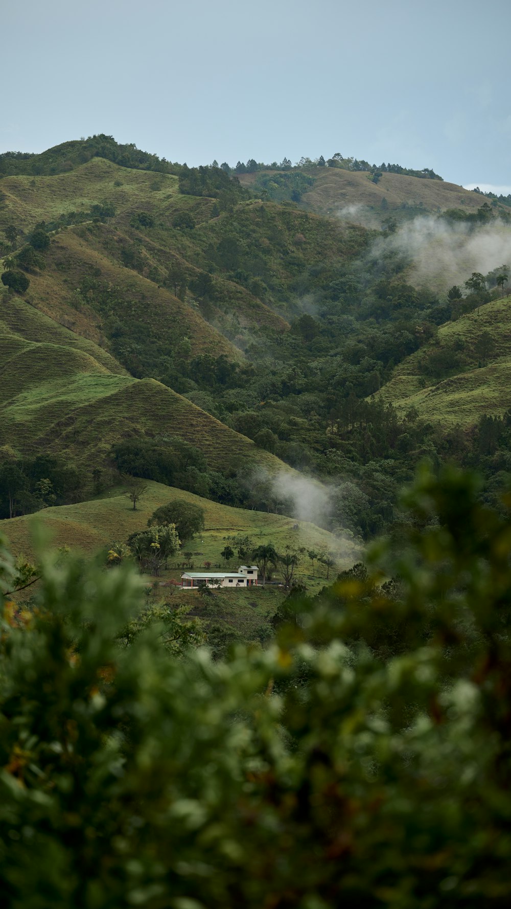 a view of a mountain with a house in the distance