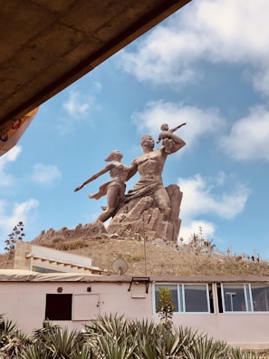 a statue of two men with guns on top of a building