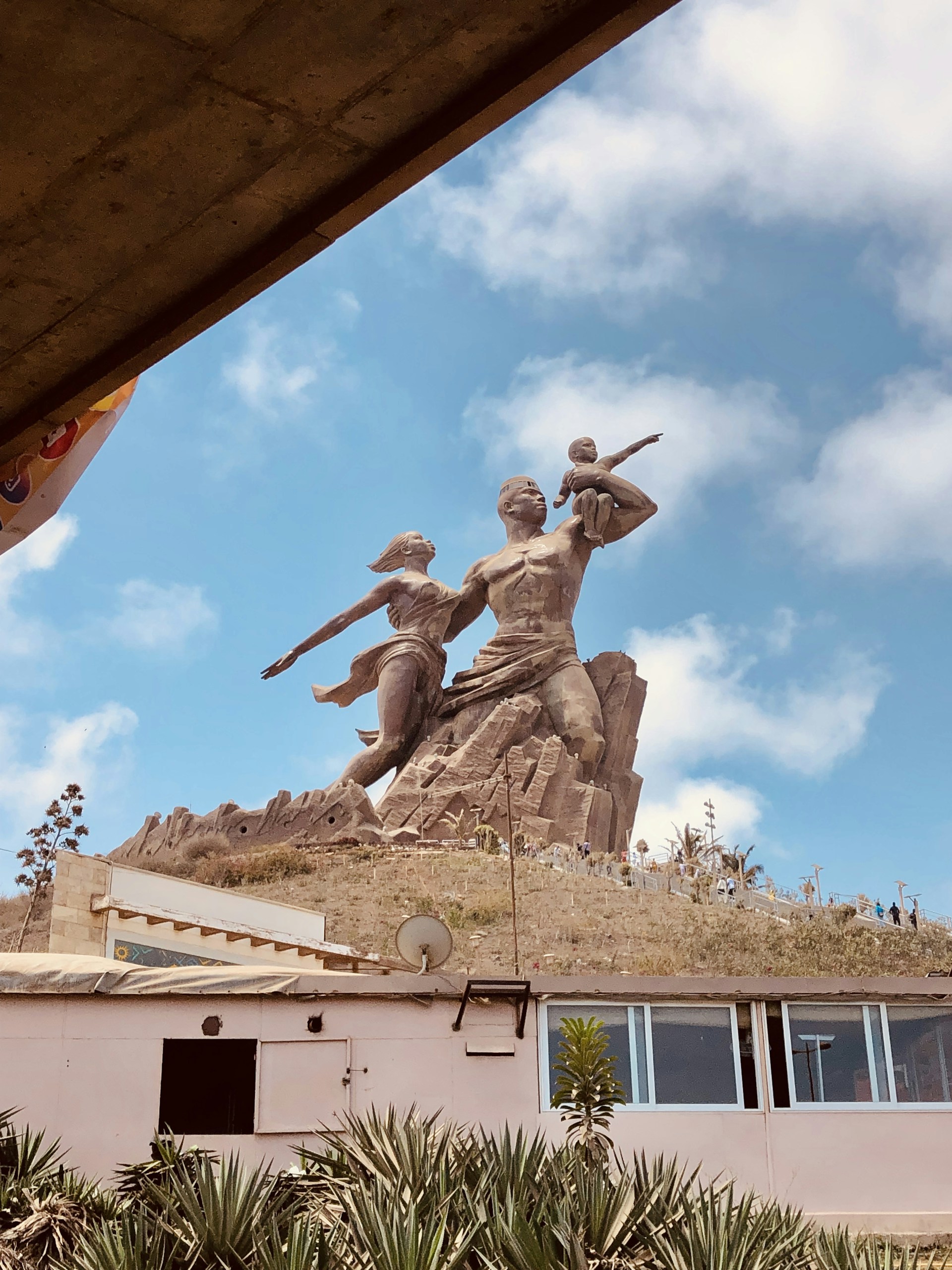 a statue of two men with guns on top of a building