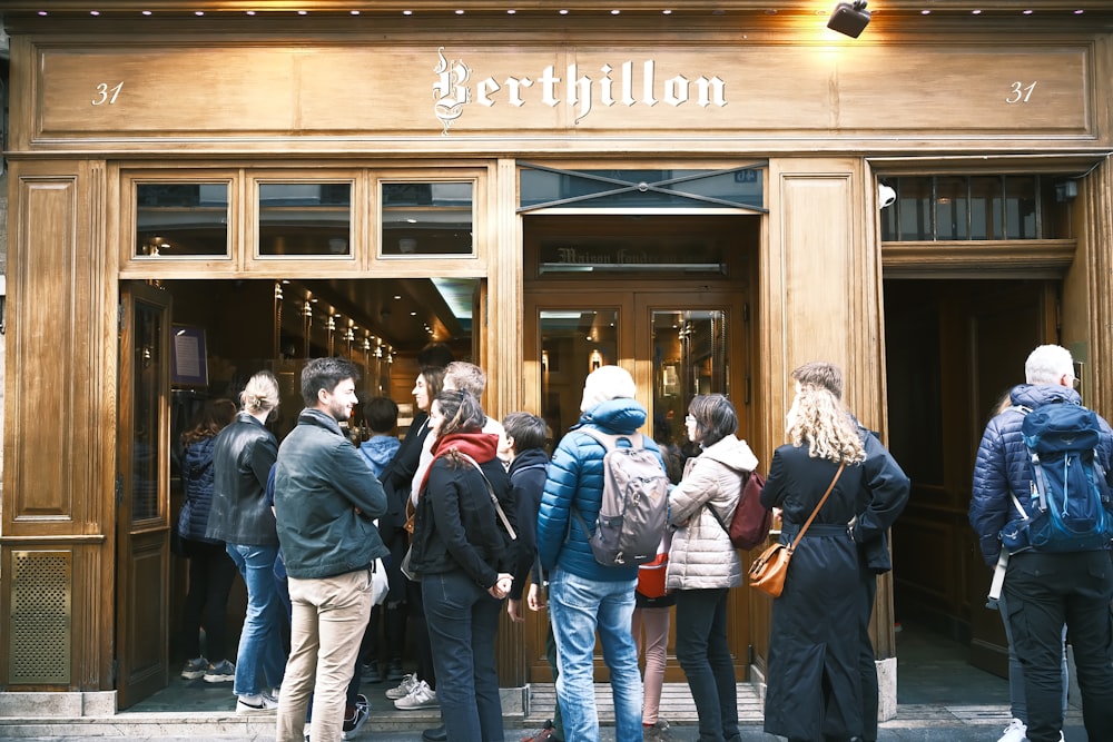 a group of people standing outside of a building