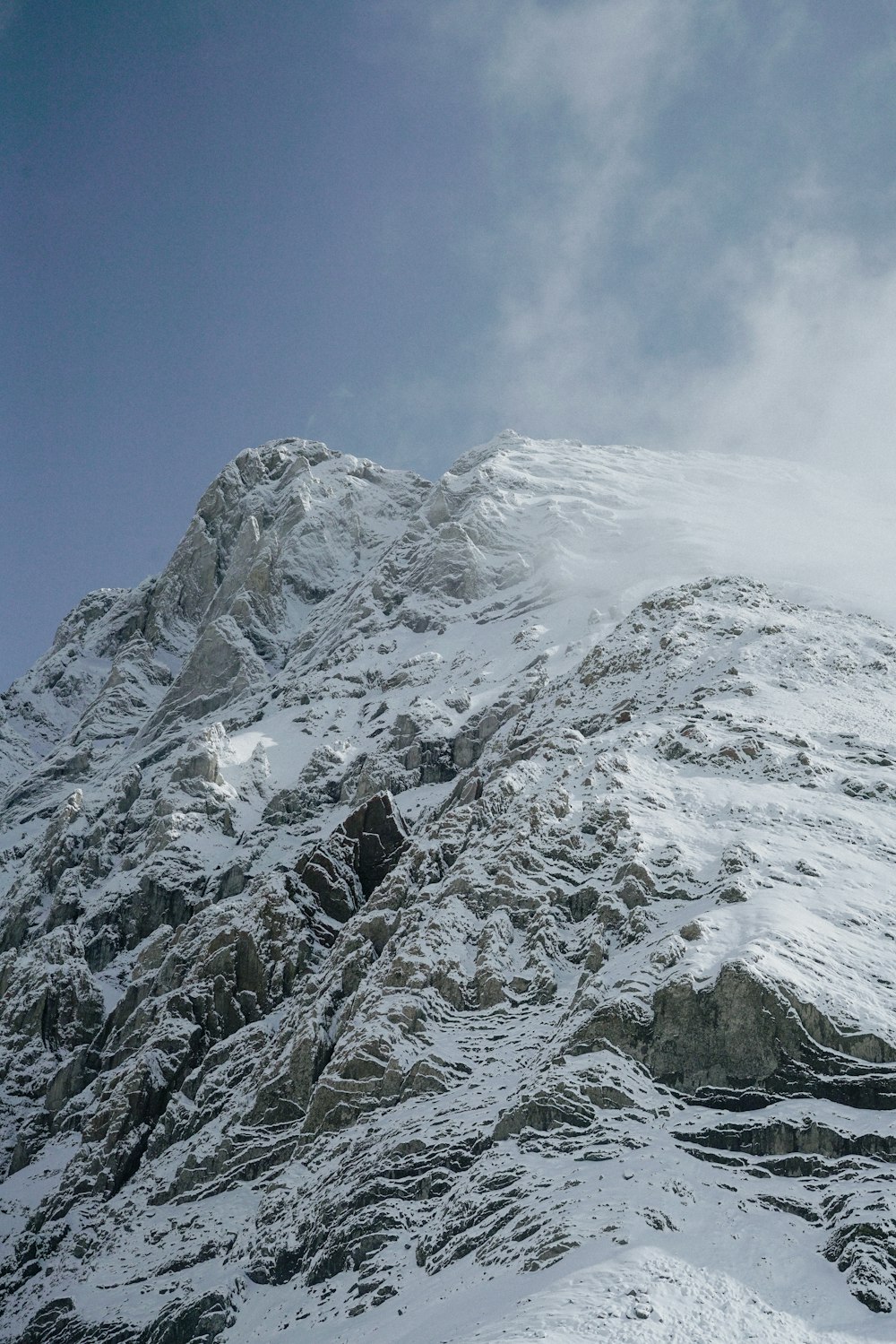 a man riding skis down the side of a snow covered mountain