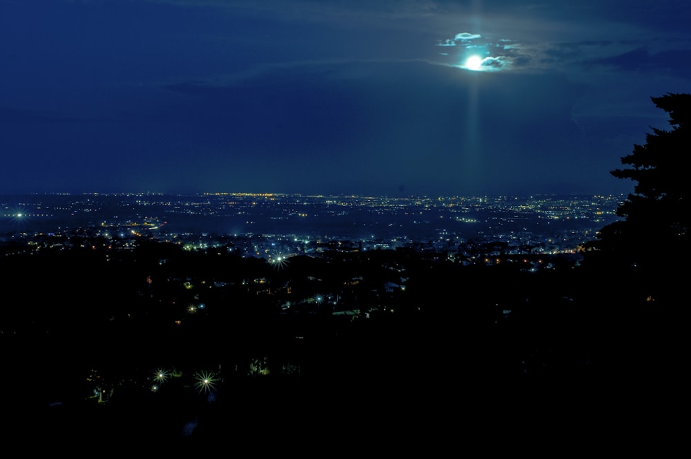 a view of a city at night from a hill