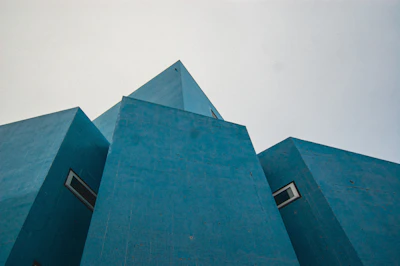 Minimalist architectural detail featuring precise angles and electric blue accent lighting.