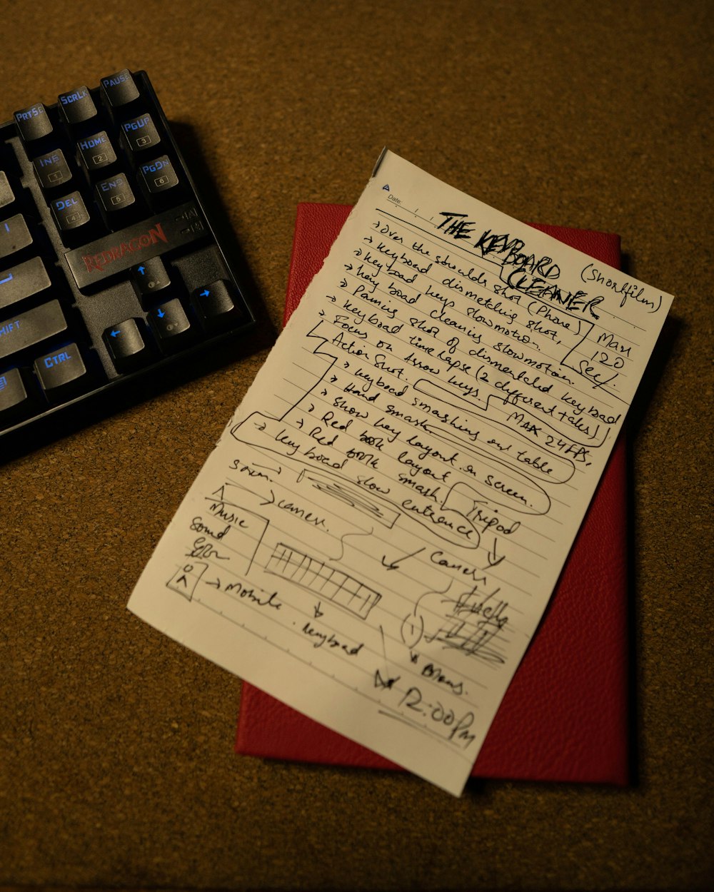 a piece of paper with writing on it next to a keyboard