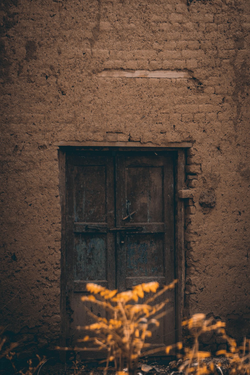 a door and window in a adobe building