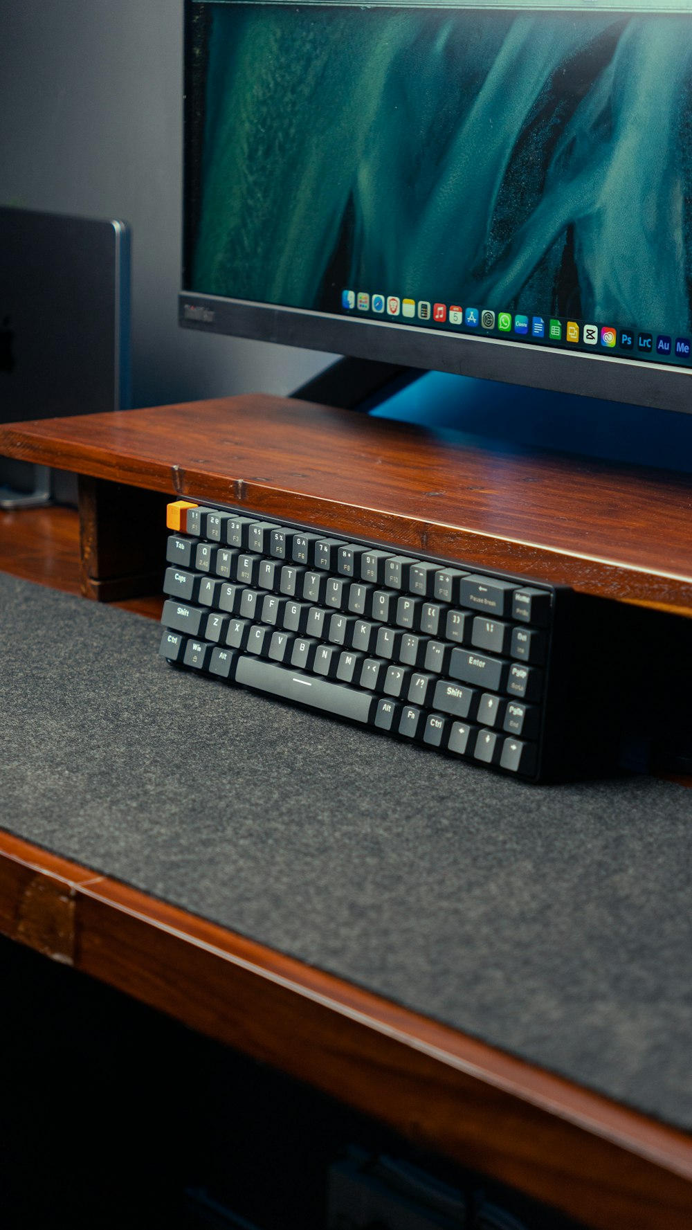 a computer keyboard sitting on top of a wooden desk