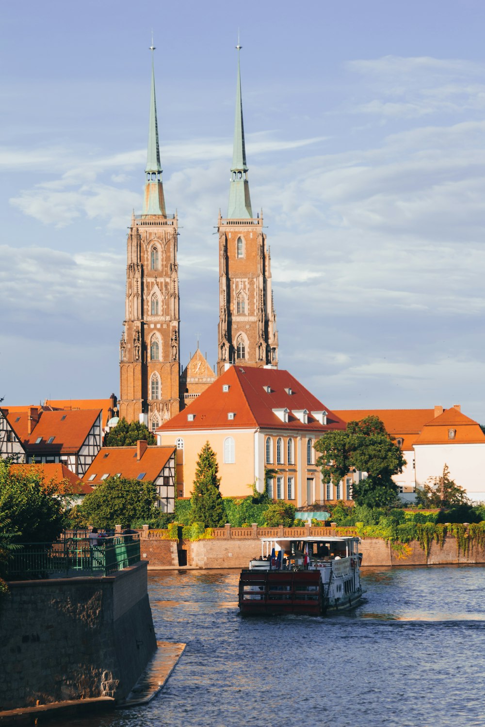 a boat traveling down a river next to a tall building