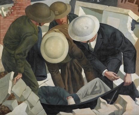 Several individuals in uniforms and helmets are gathered around a stretcher containing an unidentified person. The scene appears to take place amidst rubble and debris, suggesting a rescue or recovery operation in a post-disaster or wartime setting. The individuals are focused and engaged in their task, emphasizing a sense of urgency.