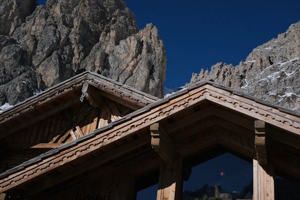 Close-up of natural wood textures and stone details on the chalet exterior.