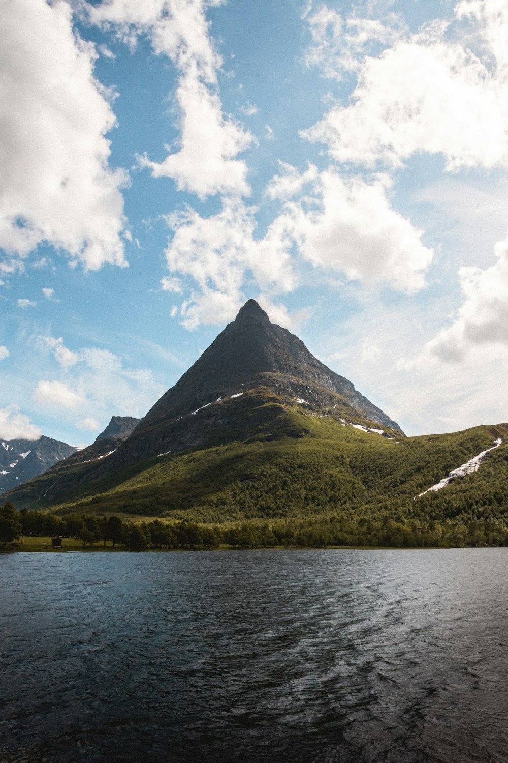 a mountain with a body of water in front of it