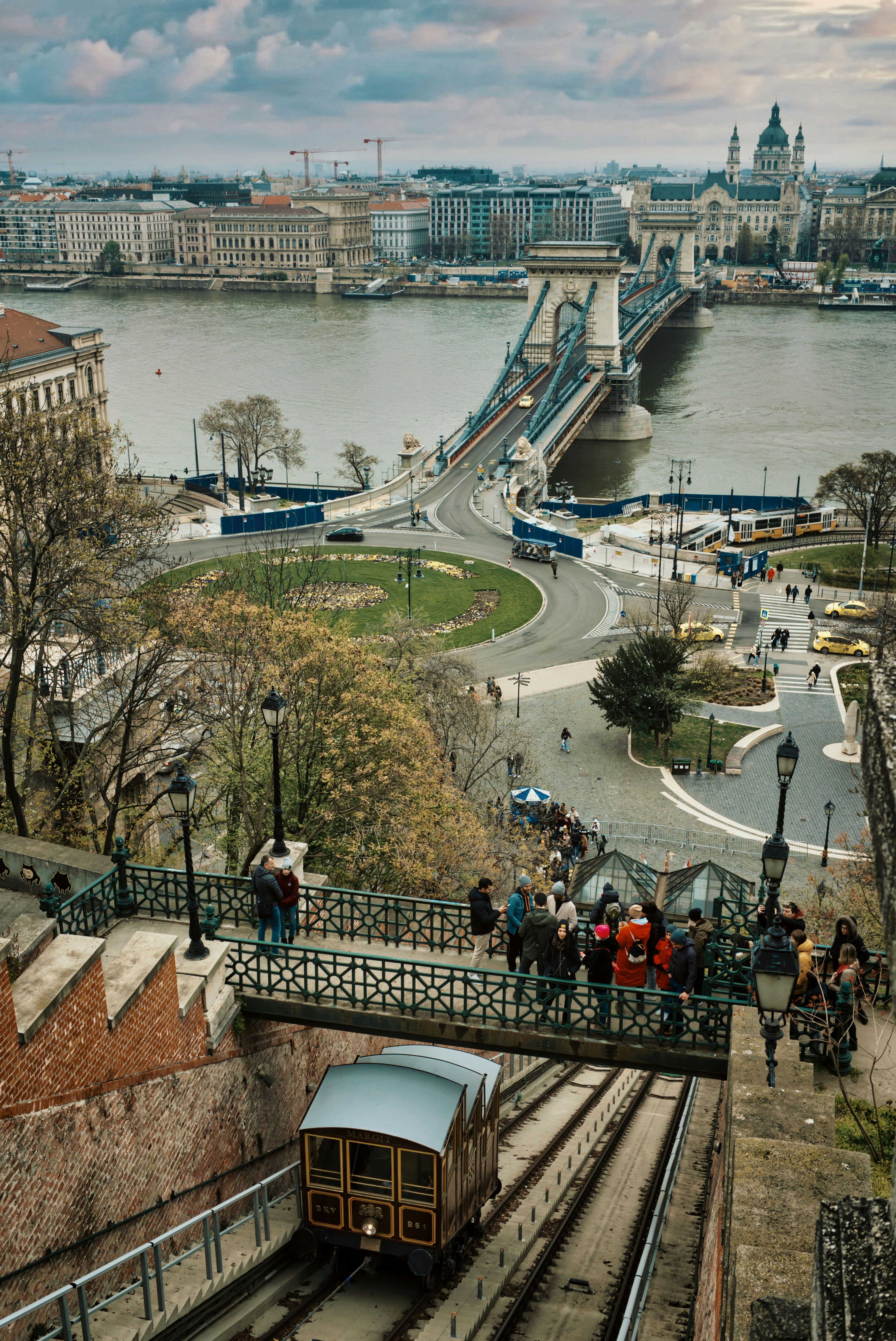 a train traveling down tracks next to a river