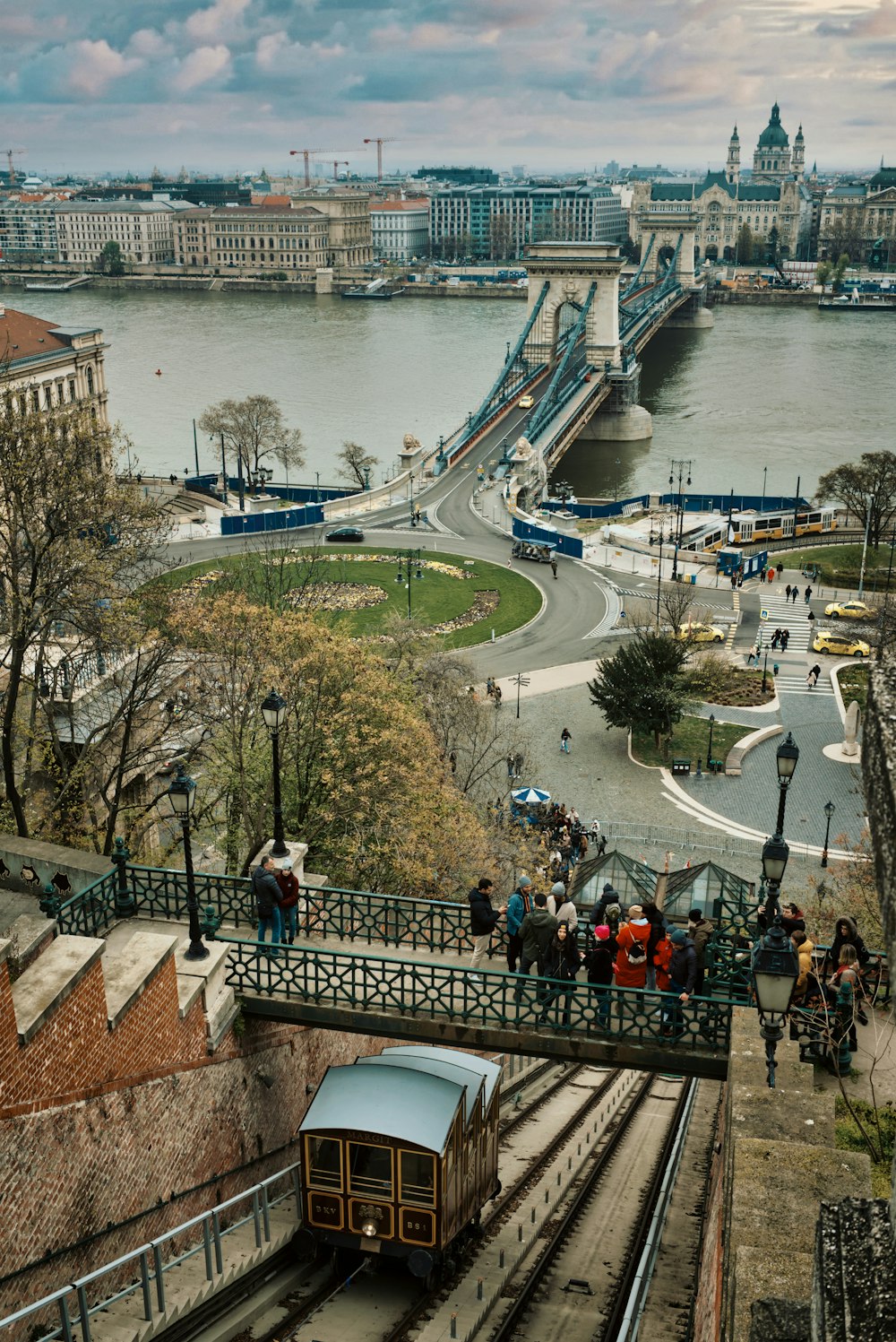 a train traveling down tracks next to a river