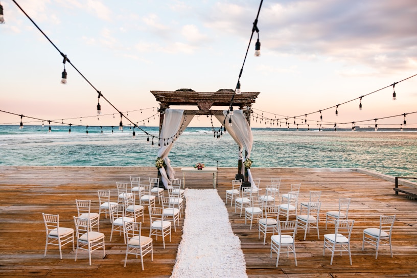 A serene outdoor wedding setup on the Costa del Sol with soft floral decorations and a gentle sea breeze.