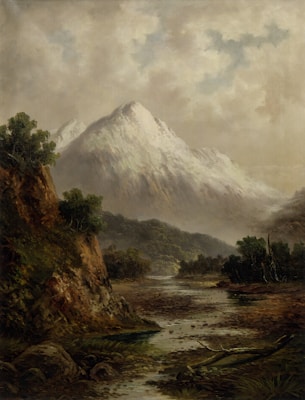 A serene landscape featuring a towering snow-capped mountain under a cloudy sky. In the foreground, a rocky terrain is intersected by a gentle stream surrounded by lush green vegetation. The setting evokes a sense of tranquility and natural beauty.
