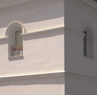 Exterior shot of a building with fresh plaster and masonry work completed.