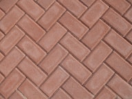 a close up of a red brick sidewalk