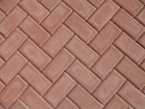 a close up of a red brick sidewalk