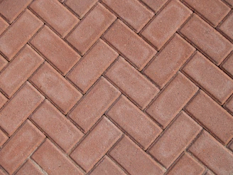 a close up of a red brick sidewalk