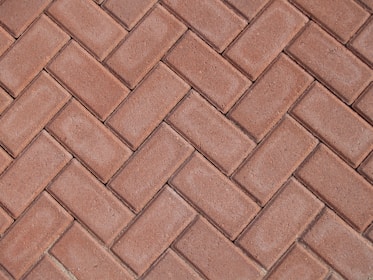a close up of a red brick sidewalk