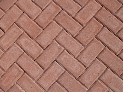 a close up of a red brick sidewalk
