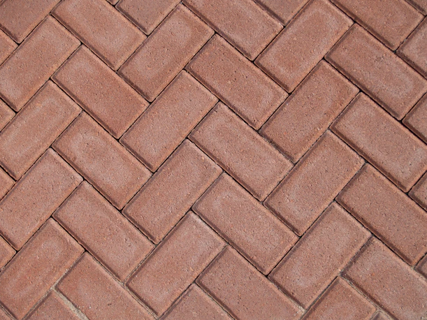 a close up of a red brick sidewalk