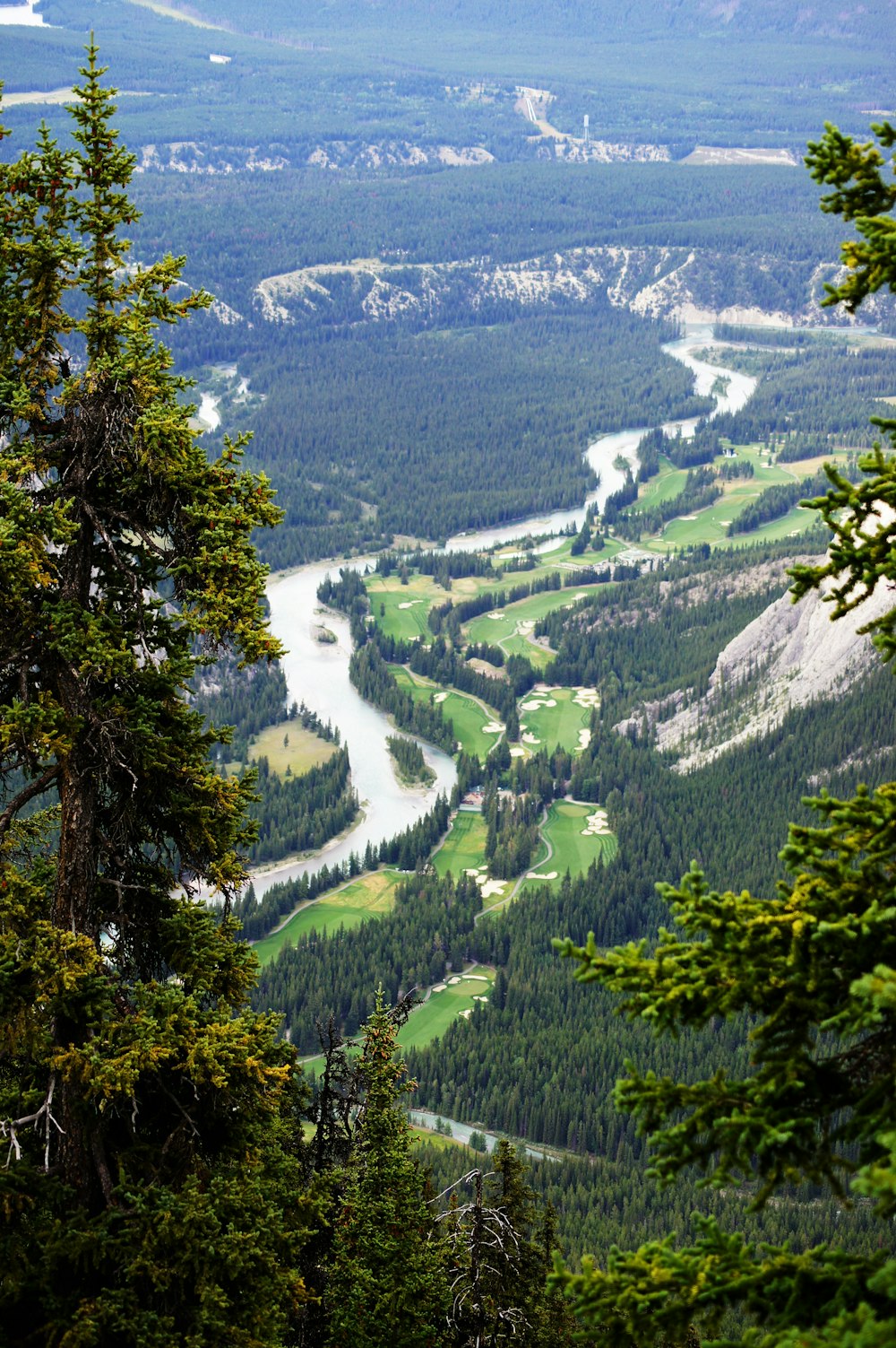 a scenic view of a valley with a river running through it