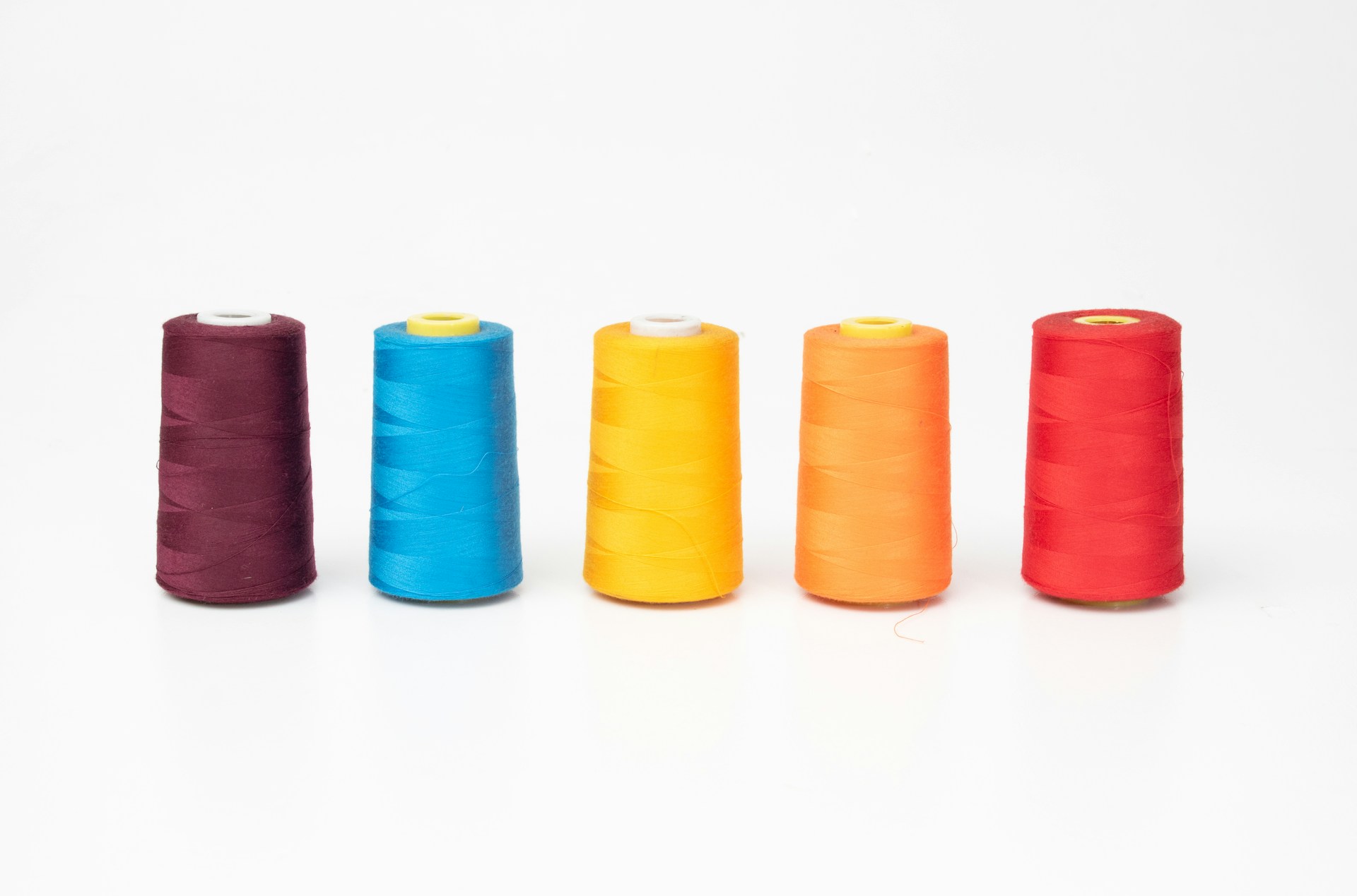 a group of spools of thread sitting next to each other