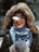 A smiling customer wearing fashionable gloves while outdoors.