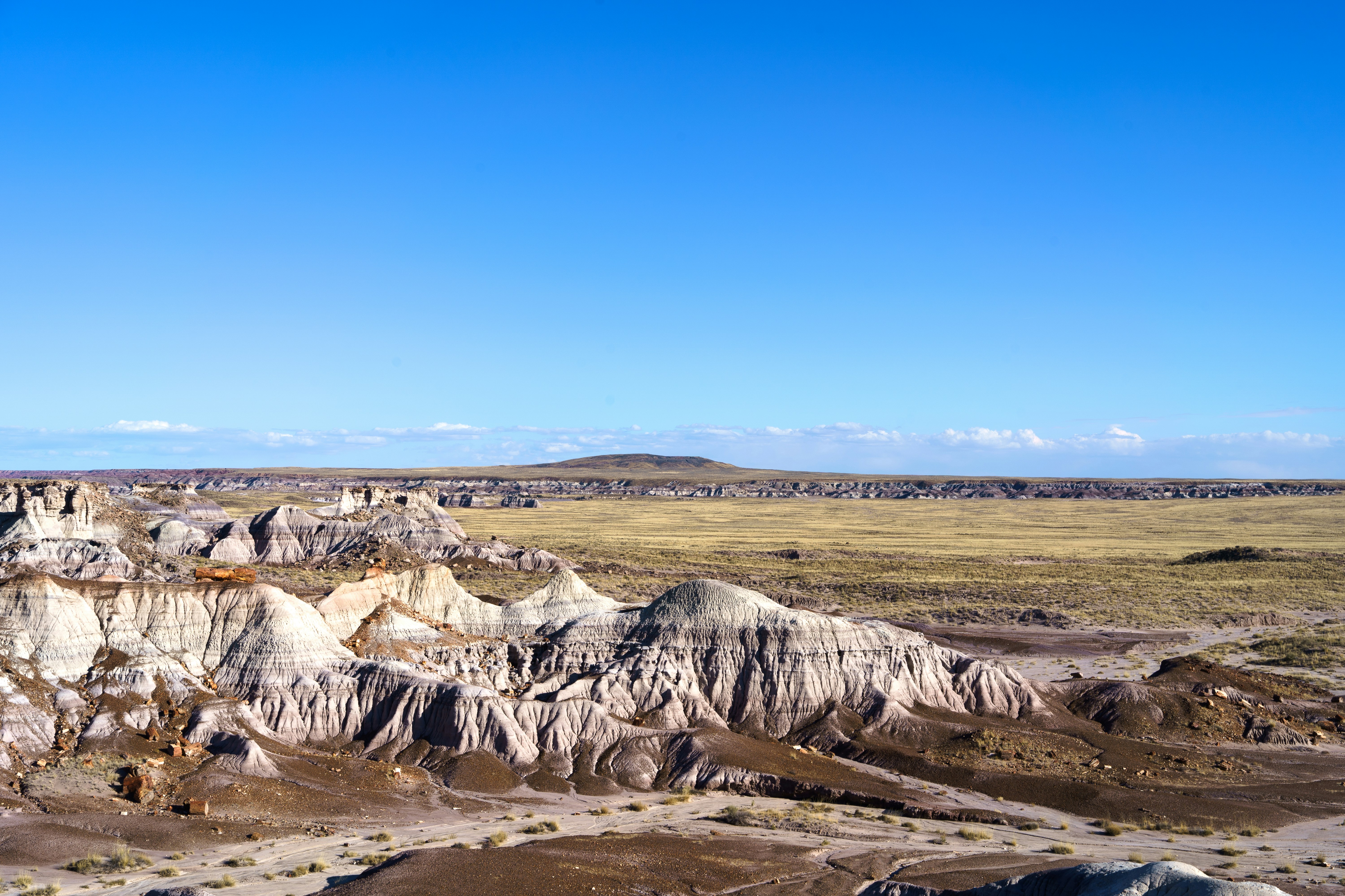 a view of a mountain range with a blue sky in the background