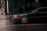 A sleek black taxi car parked on a city street.
