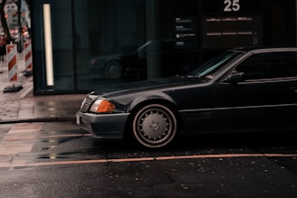 A sleek private taxi car waiting at a city street in Kuwait.