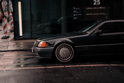 A sleek private taxi car waiting at a city street in Kuwait.