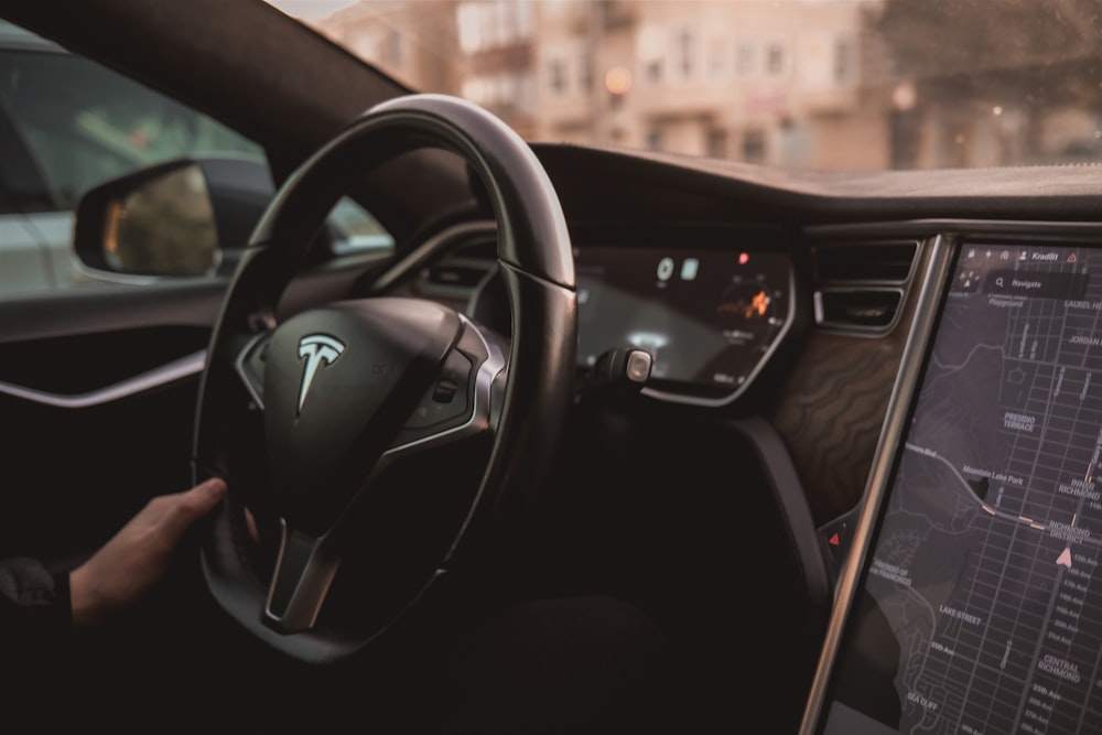 a person driving a car with a dashboard and a monitor