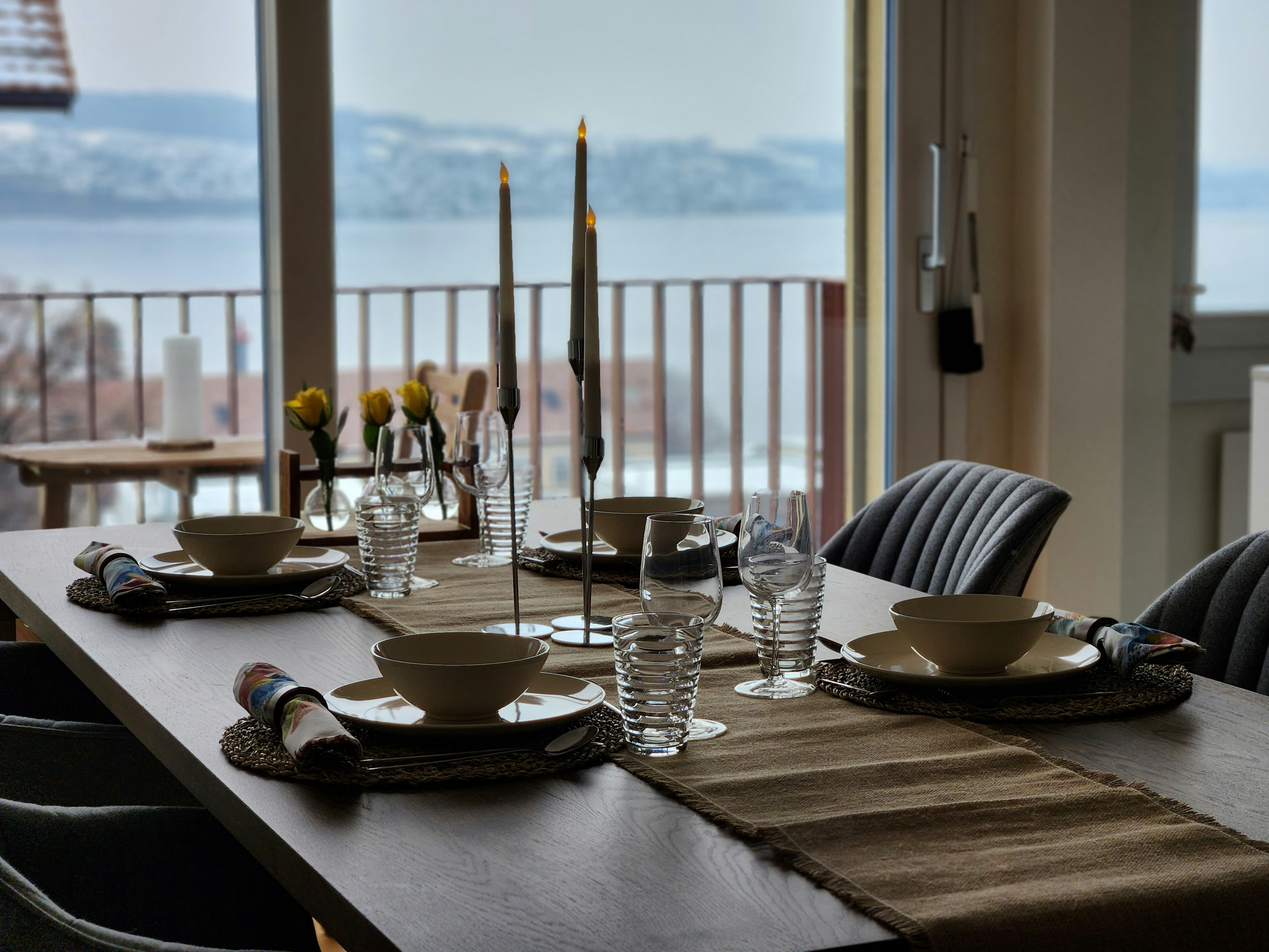 a dining table with place settings and place settings
