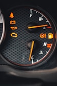 Close-up of a car dashboard showing warning lights illuminated