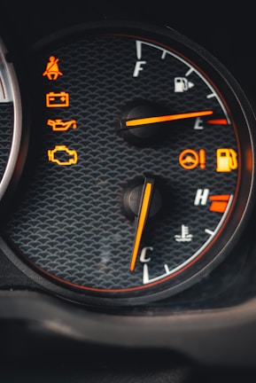 Close-up of a car dashboard showing warning lights illuminated