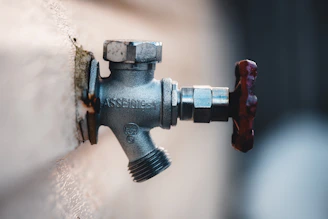 a close up of a water faucet attached to a wall