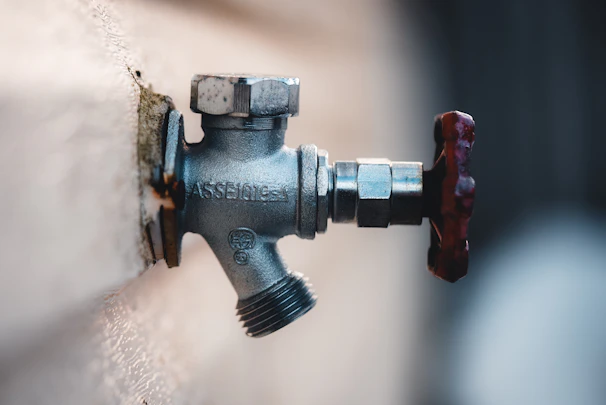 a close up of a water faucet attached to a wall