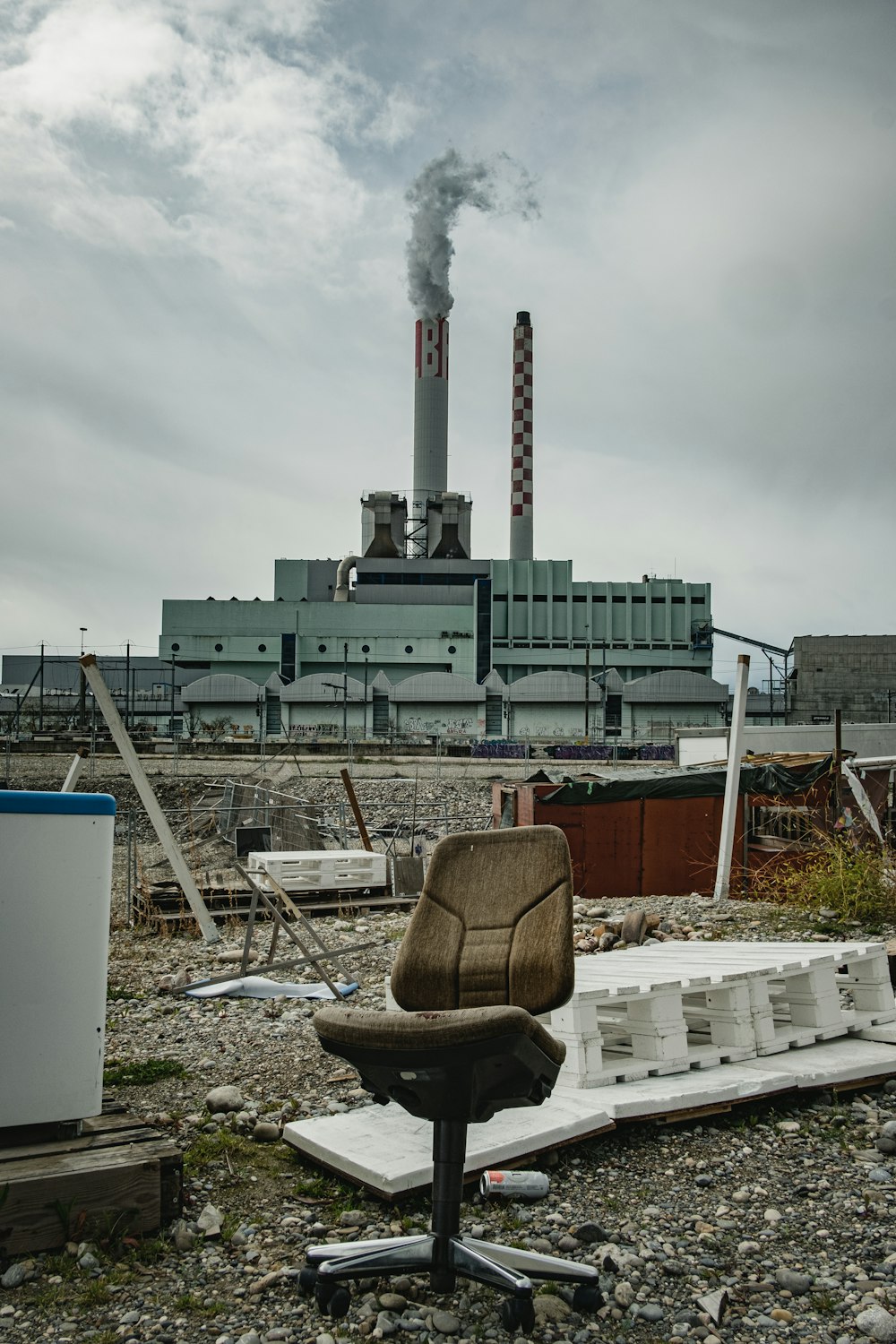 a chair sitting on top of a pile of rubble